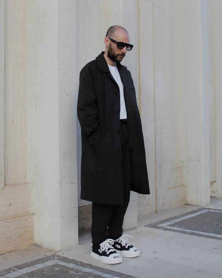 man wearing black and white sneaker